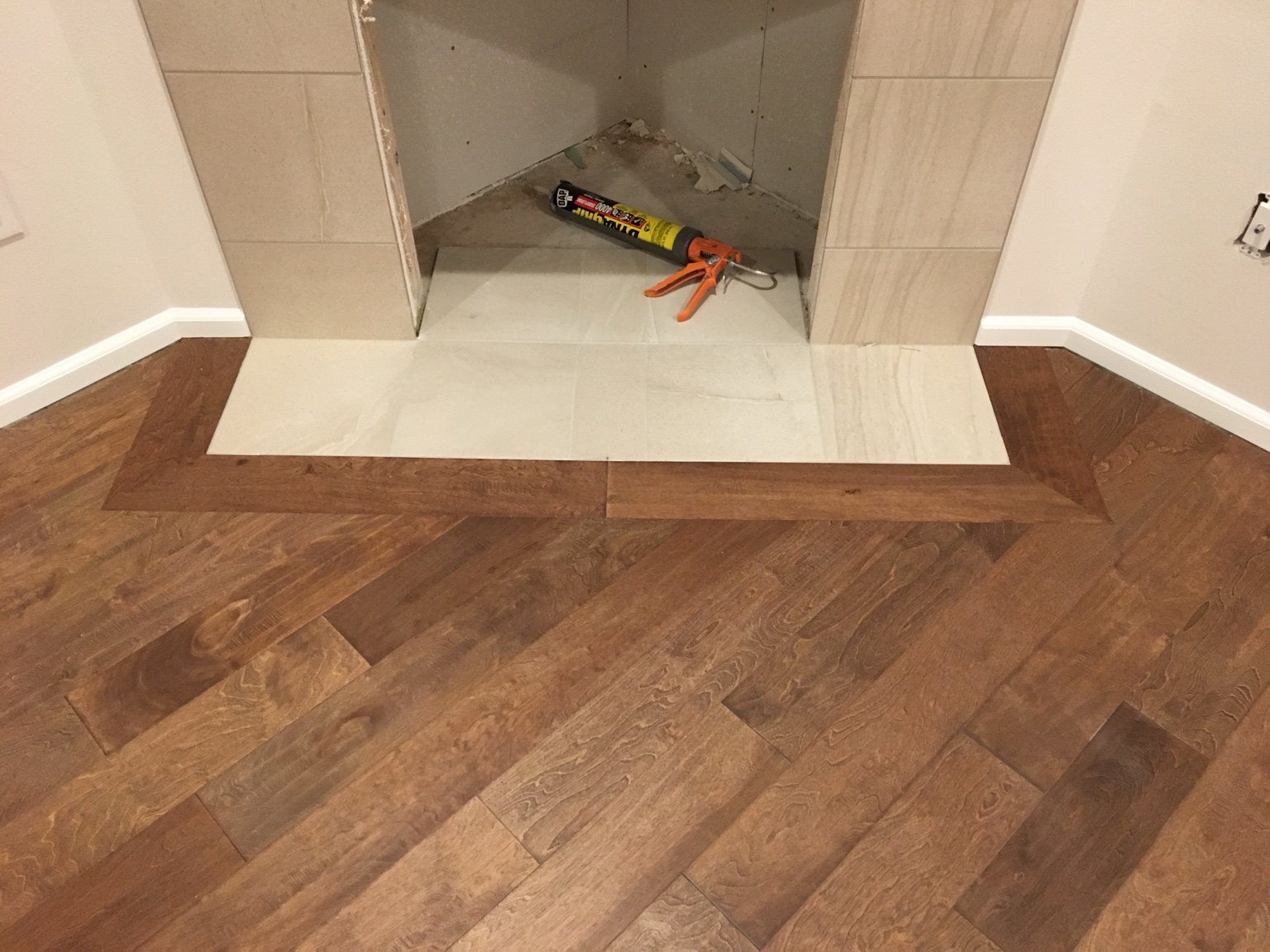 Wood flooring around fireplace tile