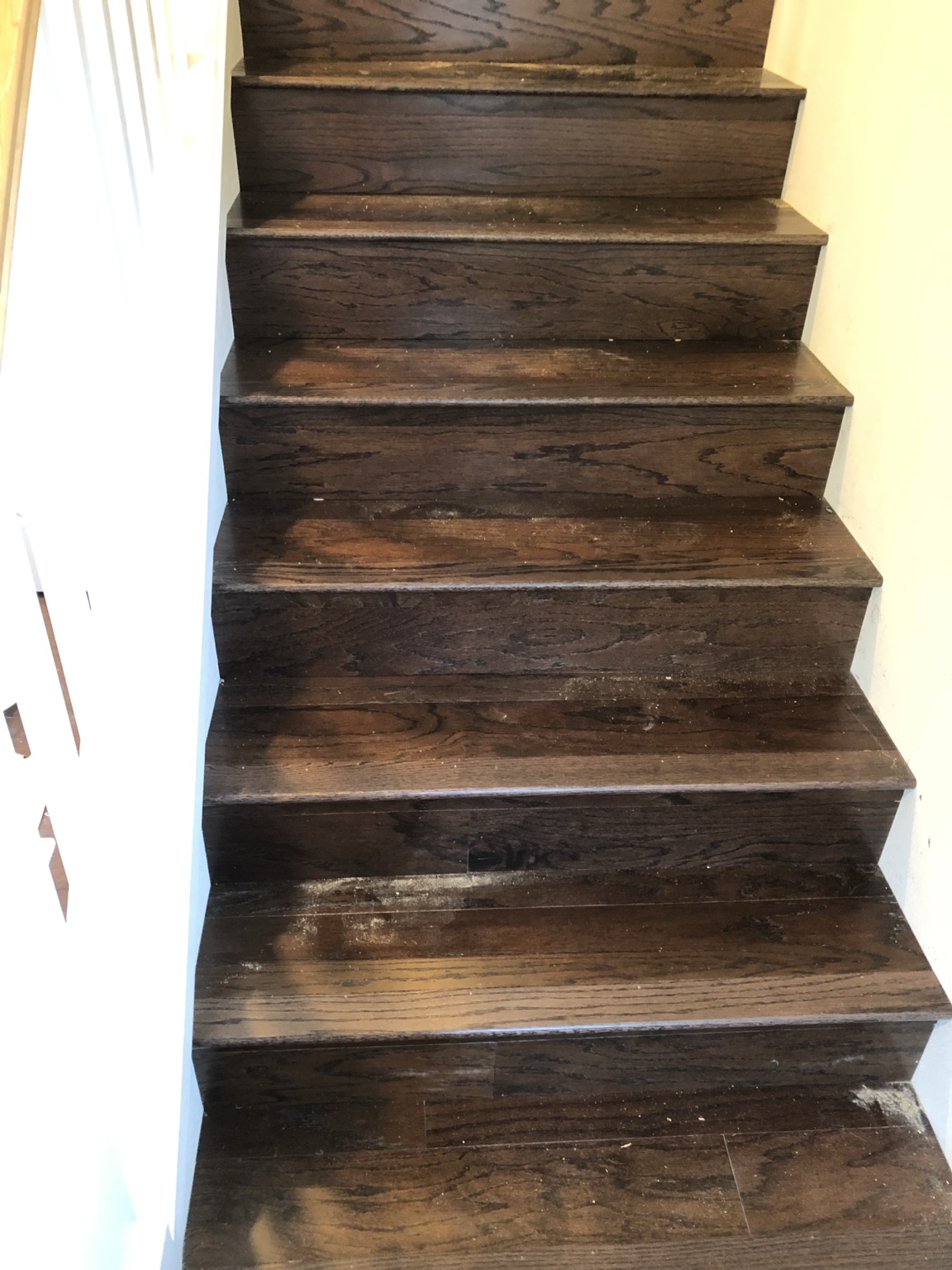 Dark hardwood stairs before cleaning and finishing